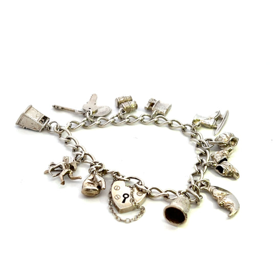Pre-Owned Silver Bracelet With Eleven Assorted Charms