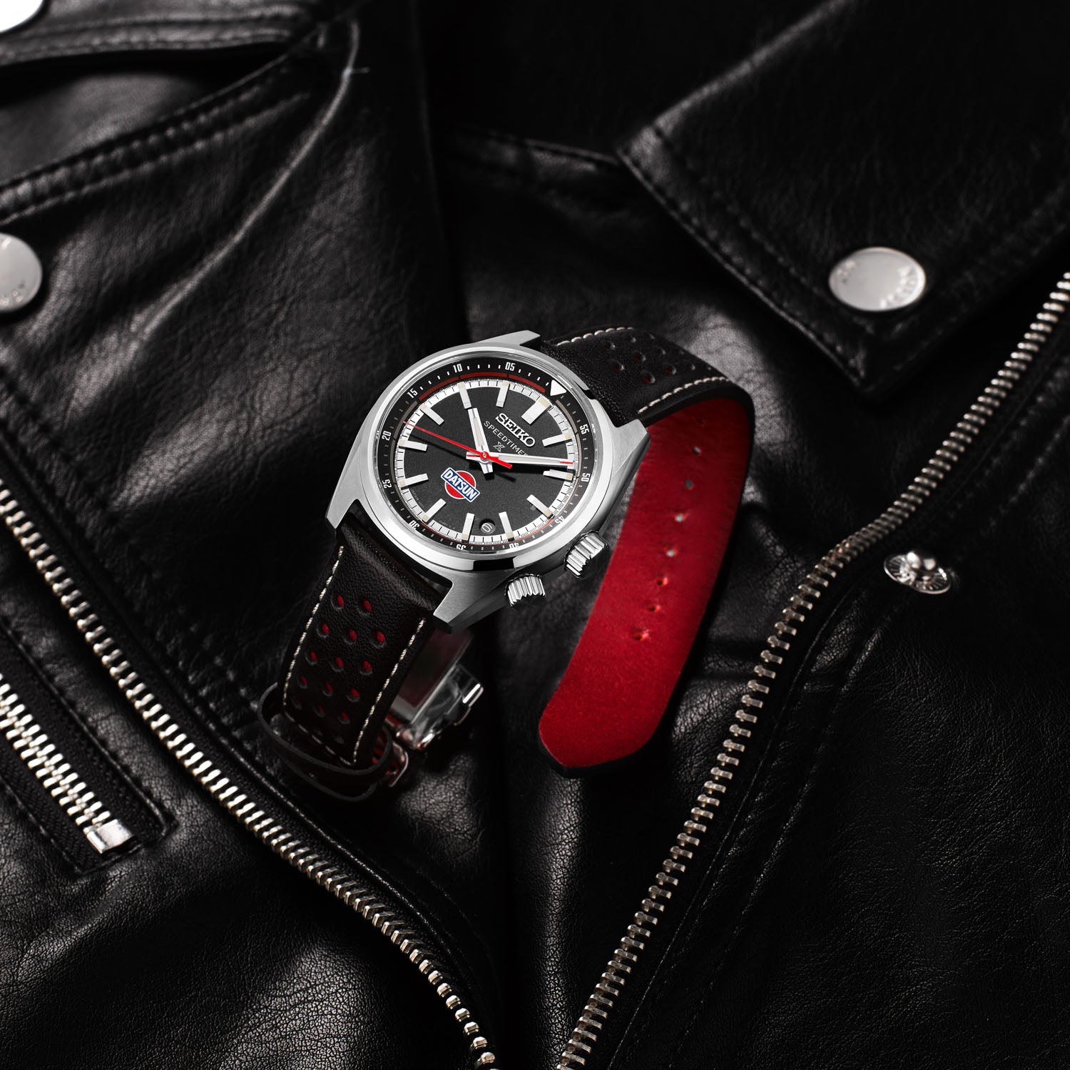 Seiko Watch with black and red strap on a black leather jacket